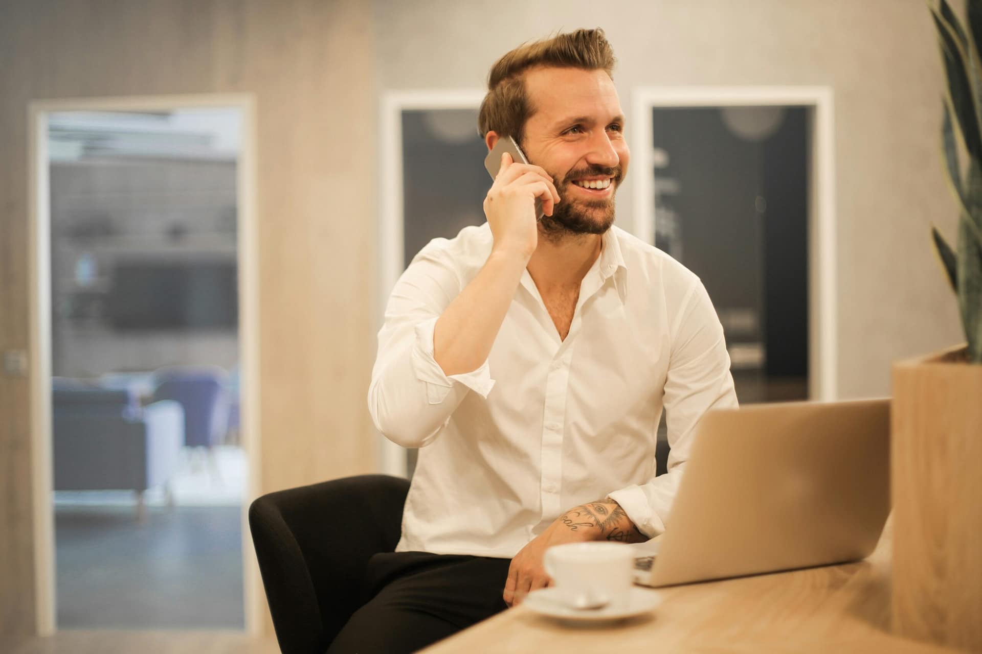 A man working on a laptop and phone, rebuilding his life after divorce