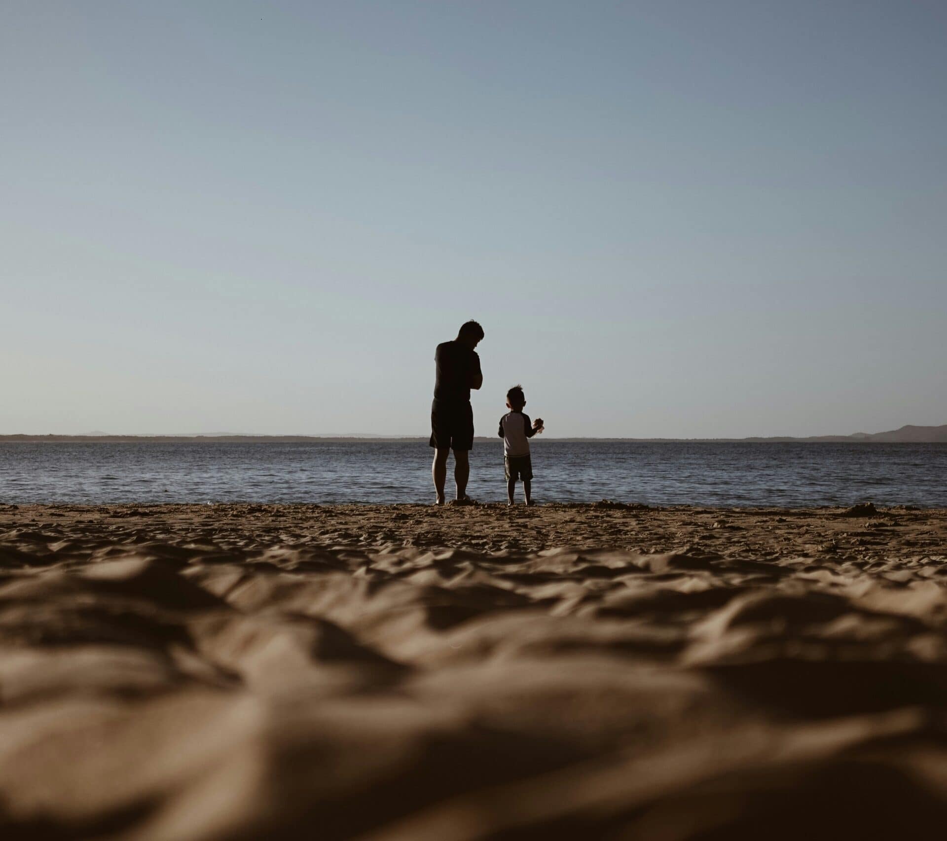 A father and child walking together as they rebuild life after divorce